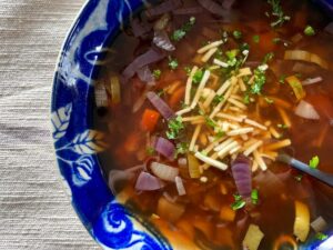 Vegan French onion soup with vegetables and vegan cheese