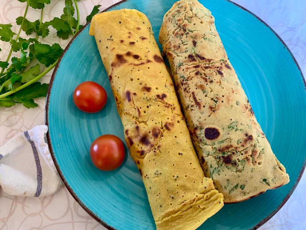 2 stuffed gram flour flatbreads on a blue plate