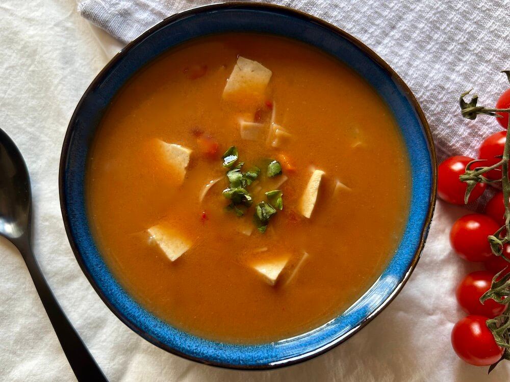 Tomato soup with added veggies, tofu and rice noodles