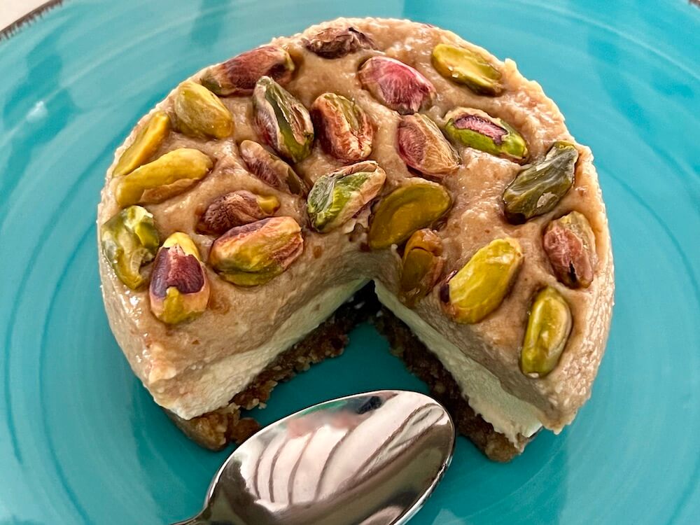Raw vegan gluten free no bake cheesecake desserts with a topping of pistachios