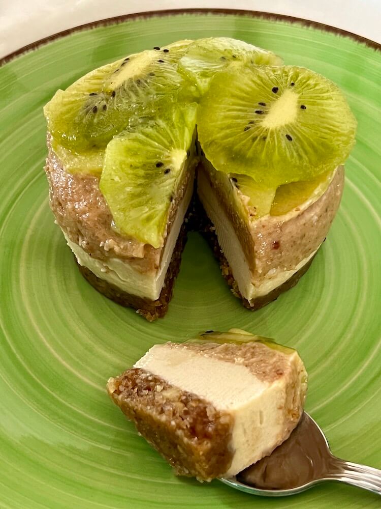 Raw vegan gluten free no bake cheesecake dessert topped with kiwi