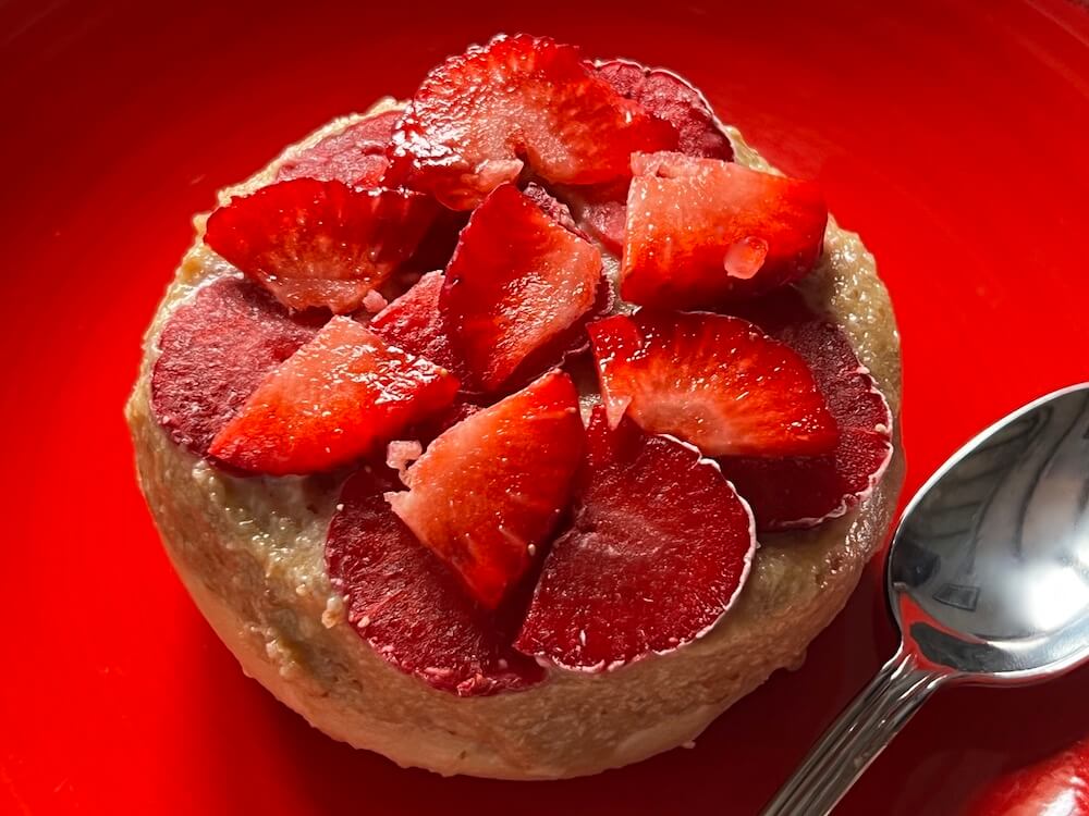Raw vegan gluten free no bake cheesecake dessert with strawberries on top