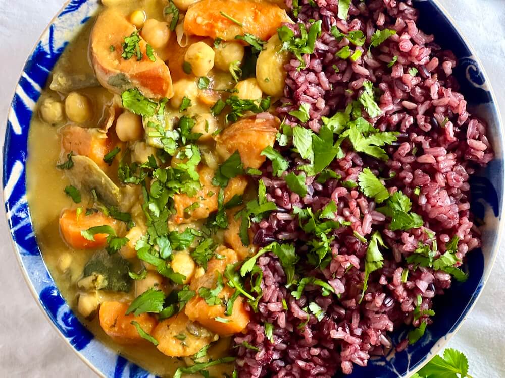 Easy sweet potato with chickpeas in coconut sauce served with rice