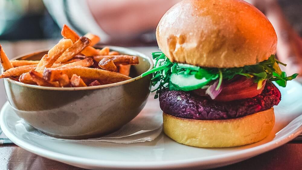 Vegan burger with sweet potato fries: vegan fast food can be unhealthy too