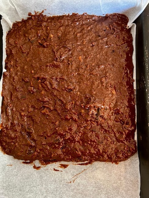 Brownie mixture in a lined baking tray