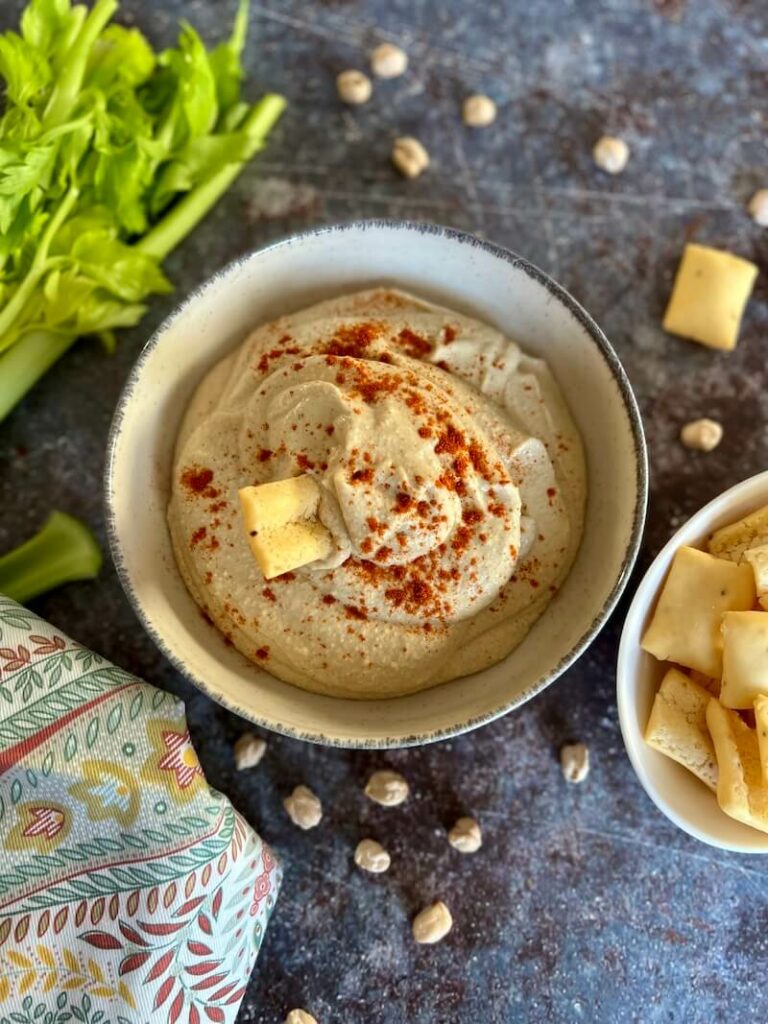 gluten free breadstick in a bowl of hummus