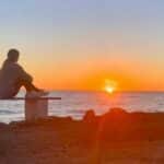 Is there a wrong way to meditate? Someone sitting overlooking the sea at sunset