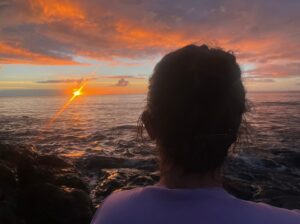 What to focus on while meditating - woman looking out to sea at sunrise