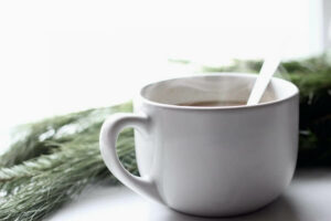 Can you drink vegetable broth while fasting? Cup of vegetable broth with a spoon in it.