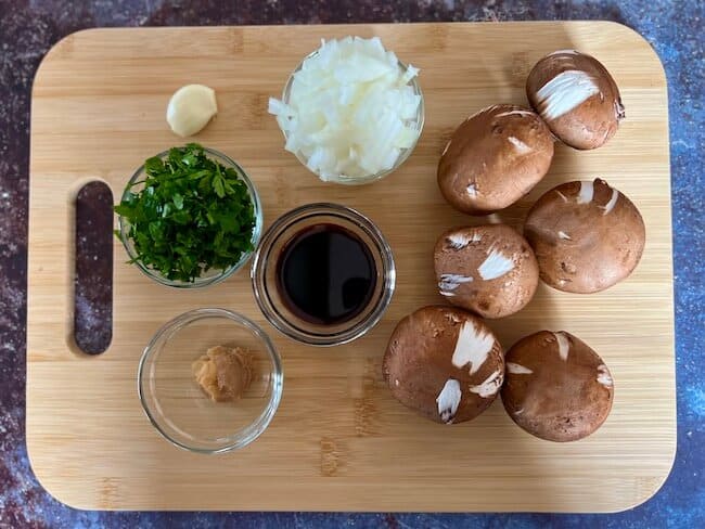 Ingredients for a vegan oil-free mushroom gravy laid out on a chopping board