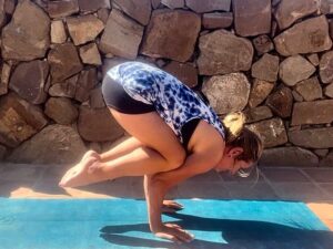 Is Yogi Flight School good for older students? Middle aged woman doing crow pose