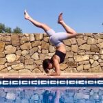 Life lessons from Yogi Flight School - Picture of Aisha Perks next to a pool practising forearm balance, Pincha