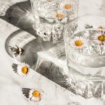 Two glasses of water with flowers floating in the water - the role of water on an OMAD diet