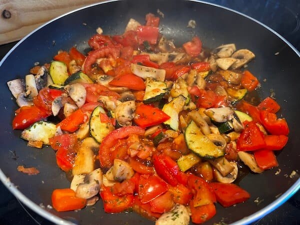 Cooking mushrooms, red pepper, tomato and courgette for WFPB mushroom pasta