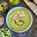 Bowl of cucumber and avocado gazpacho with a swirl of vegan cream on top